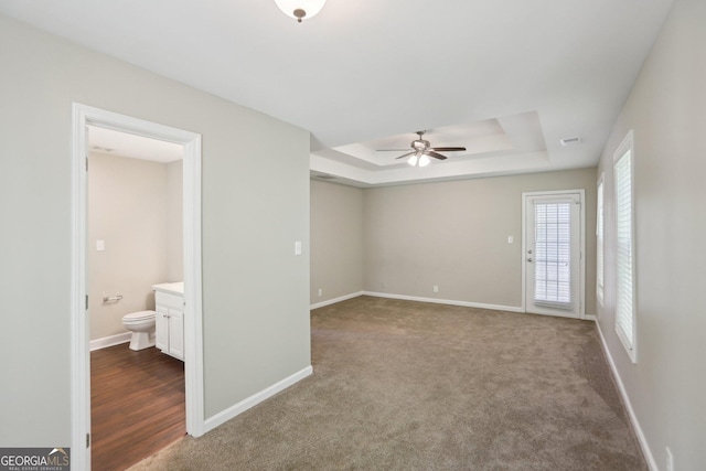 1945 Grayson Oaks Ct, Lawrenceville, GA 30045 - spare room with a raised ceiling, baseboards, a ceiling fan, and visible vents