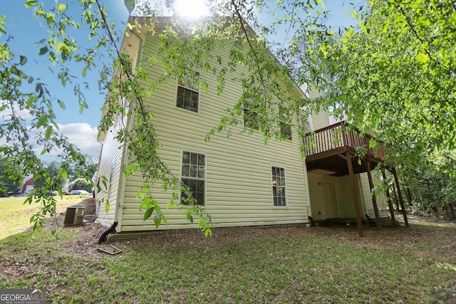 1945 Grayson Oaks Ct, Lawrenceville, GA 30045 - back of property with a lawn, central AC, and a wooden deck