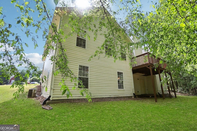 1945 Grayson Oaks Ct, Lawrenceville, GA 30045 - rear view of property featuring a lawn, central air condition unit, and a deck