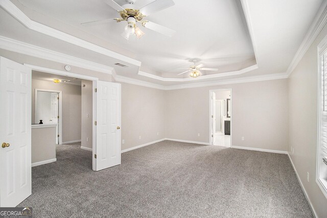 1085 Crown River Pkwy, Mcdonough, GA 30252 - carpeted spare room with crown molding, a raised ceiling, a ceiling fan, and plenty of natural light