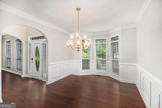 1085 Crown River Pkwy, Mcdonough, GA 30252 - entrance foyer featuring baseboards, arched walkways, crown molding, and dark wood-type flooring
