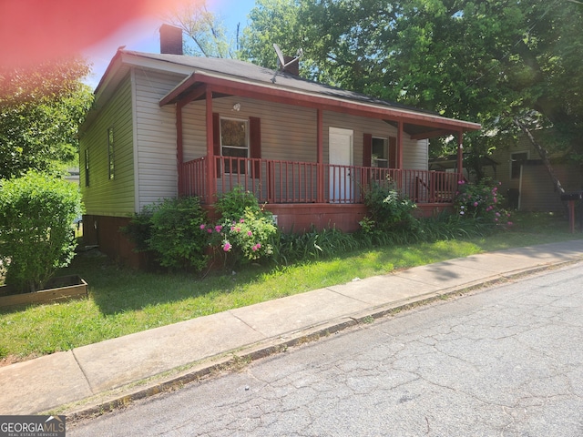 4 Maple St, Porterdale, GA 30014 - bungalow-style home featuring a porch and a chimney
