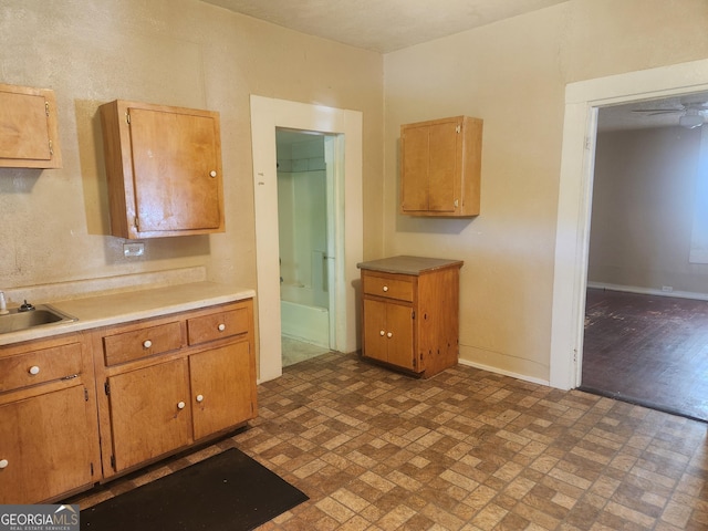 4 Maple St, Porterdale, GA 30014 - kitchen featuring brick patterned floor, light countertops, baseboards, and a sink