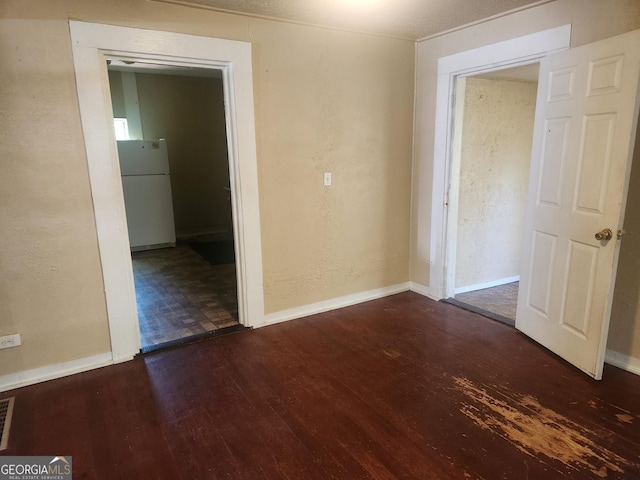 4 Maple St, Porterdale, GA 30014 - unfurnished room with baseboards, dark wood-style floors, and a textured wall