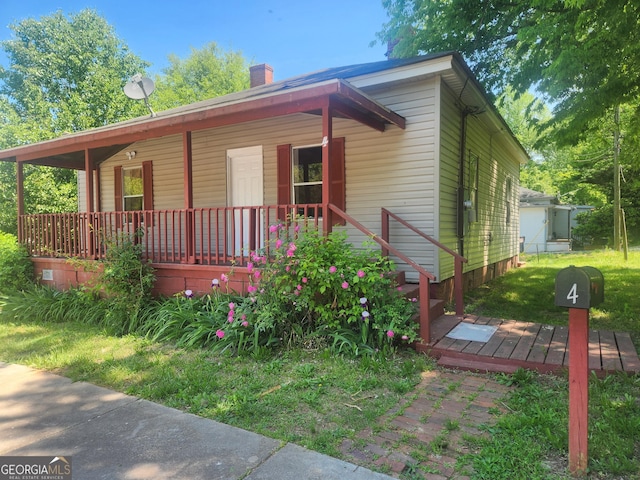 4 Maple St, Porterdale, GA 30014 - bungalow-style home featuring a chimney and covered porch