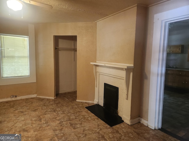 4 Maple St, Porterdale, GA 30014 - unfurnished living room featuring a fireplace with flush hearth and a ceiling fan
