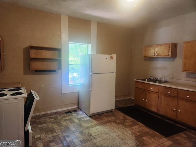 4 Maple St, Porterdale, GA 30014 - kitchen with a sink, brown cabinetry, white appliances, light countertops, and visible vents