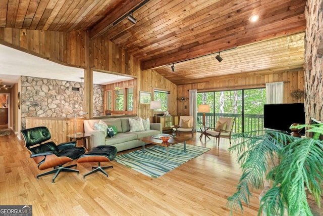living room with wood ceiling, wood finished floors, beam ceiling, and wooden walls