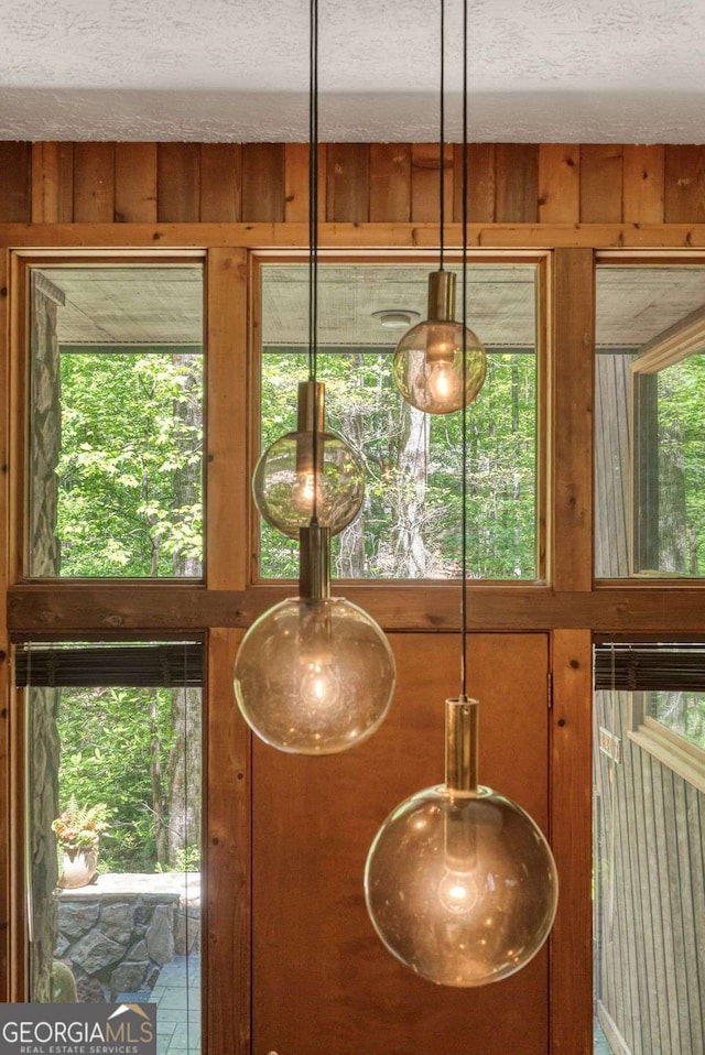 details with a textured ceiling and wooden walls