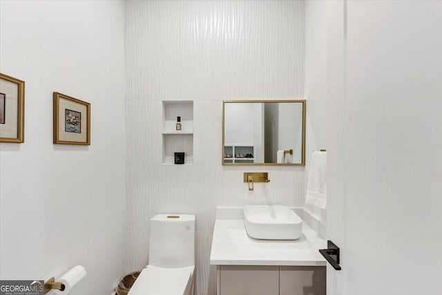 half bathroom with toilet and vanity
