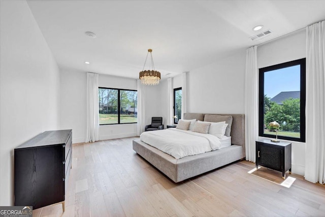 bedroom featuring a chandelier, light wood-style floors, visible vents, and recessed lighting