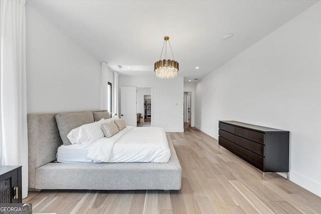 bedroom featuring recessed lighting, baseboards, an inviting chandelier, and light wood-style flooring