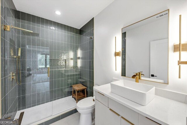 full bath with tile patterned floors, visible vents, toilet, vanity, and a stall shower