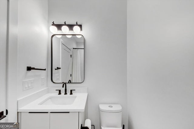 bathroom featuring vanity and toilet