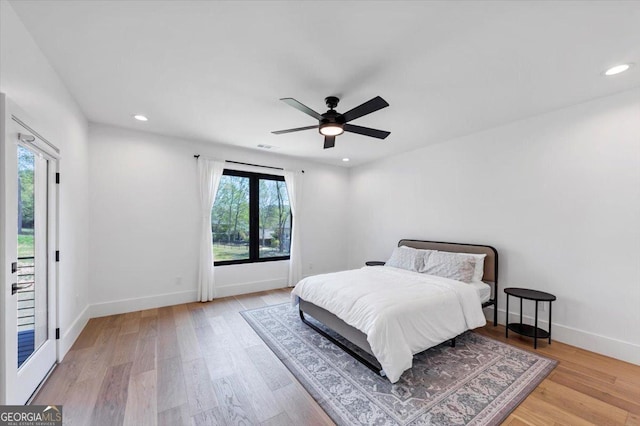 bedroom featuring baseboards, wood finished floors, recessed lighting, and ceiling fan