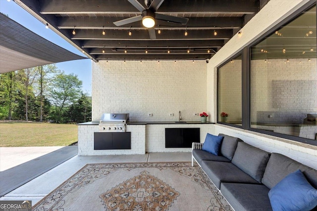 view of patio / terrace with an outdoor kitchen, a ceiling fan, a sink, an outdoor hangout area, and grilling area