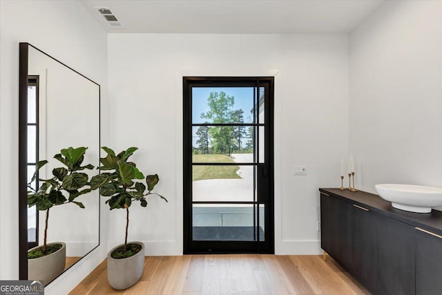 doorway to outside featuring visible vents and light wood-style floors