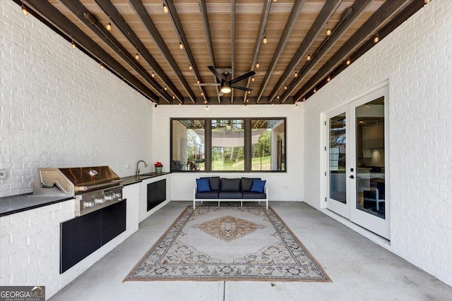view of patio / terrace featuring a ceiling fan, exterior kitchen, grilling area, french doors, and an outdoor living space