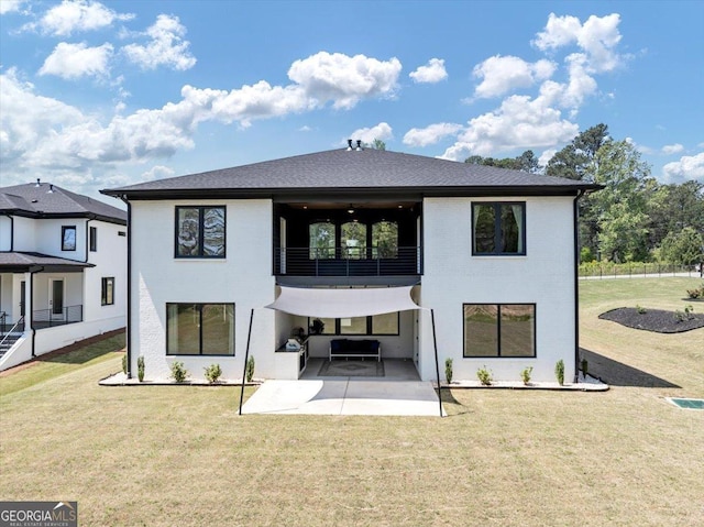 back of house with a lawn, a patio, and a balcony