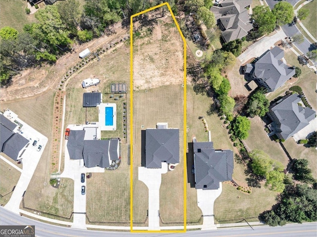 birds eye view of property with a residential view