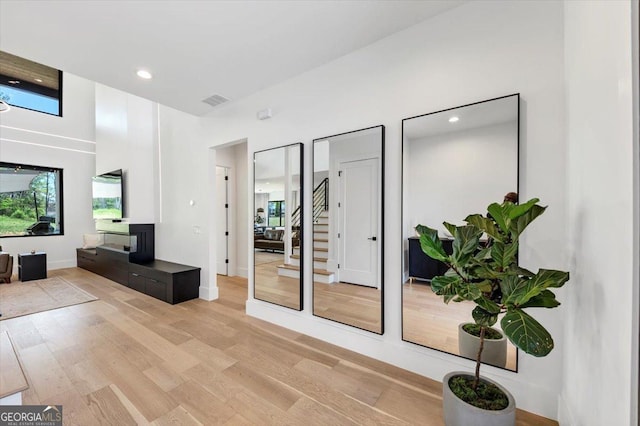 interior space with recessed lighting, visible vents, a fireplace, and light wood-style floors