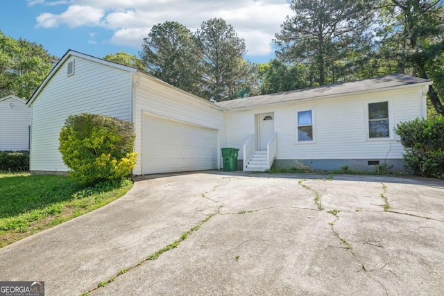 ranch-style home featuring an attached garage, crawl space, driveway, and entry steps