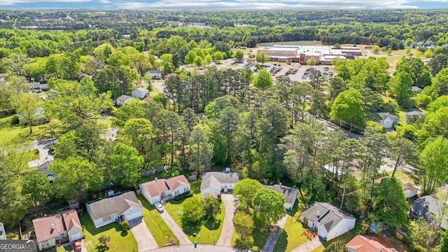 bird's eye view with a wooded view