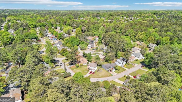 birds eye view of property featuring a residential view and a wooded view