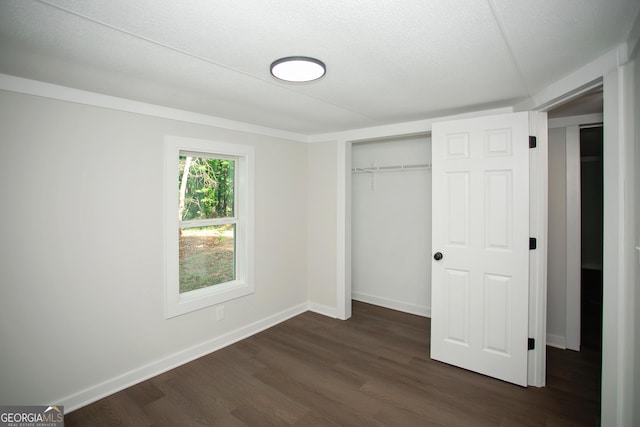 216 Howard Rd, Barnesville, GA 30204 - unfurnished bedroom with dark wood finished floors, baseboards, and a closet