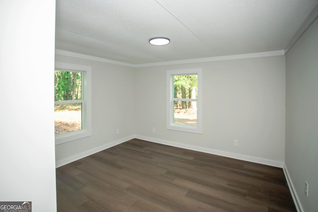 216 Howard Rd, Barnesville, GA 30204 - spare room with healthy amount of natural light, dark wood finished floors, baseboards, and ornamental molding