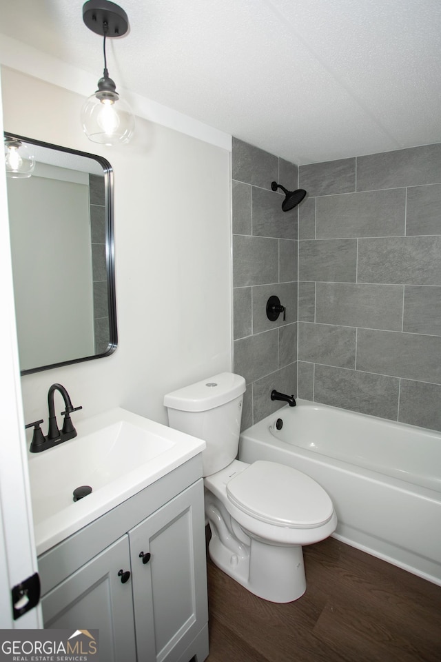 216 Howard Rd, Barnesville, GA 30204 - full bathroom with wood finished floors, vanity, toilet, and washtub / shower combination