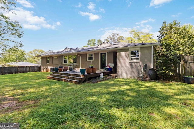 back of house with a lawn, a fenced backyard, and a deck