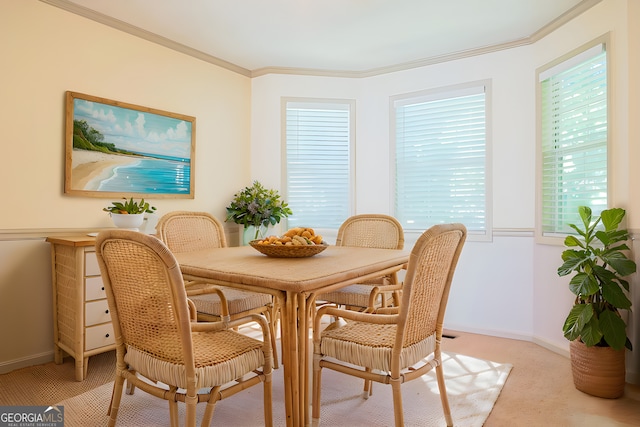 1166 Memory Ln, Lawrenceville, GA 30044 - dining area featuring light colored carpet, crown molding, healthy amount of natural light, and baseboards