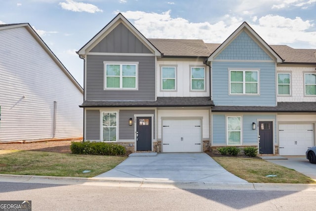 130 Magnolia Pl, Homer, GA 30547 - view of front of property featuring board and batten siding, roof with shingles, concrete driveway, a garage, and a front lawn