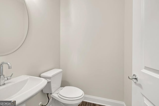 130 Magnolia Pl, Homer, GA 30547 - half bathroom featuring a sink and wood finished floors