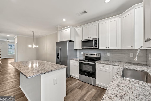 130 Magnolia Pl, Homer, GA 30547 - kitchen with appliances with stainless steel finishes, ornamental molding, a center island, recessed lighting, and backsplash