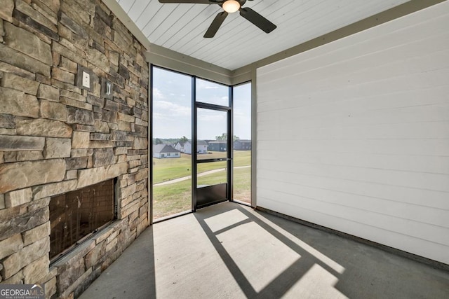130 Magnolia Pl, Homer, GA 30547 - unfurnished sunroom with a ceiling fan and a stone fireplace