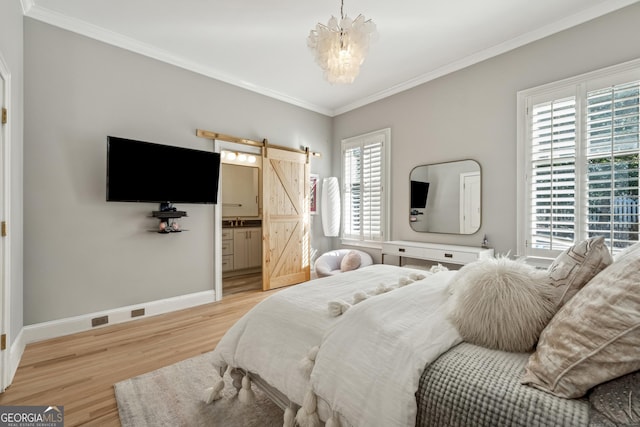 bedroom featuring a barn door, an inviting chandelier, light wood finished floors, baseboards, and ornamental molding