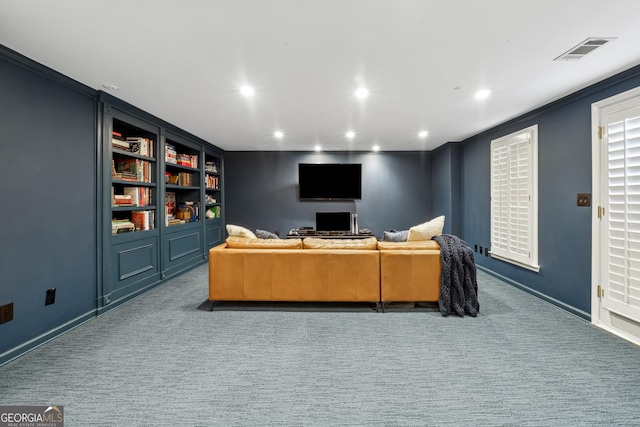 carpeted living area featuring baseboards, crown molding, visible vents, and recessed lighting