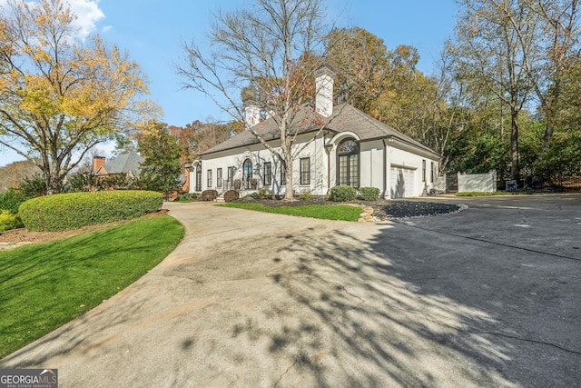 4341 Quail Ridge Way, Peachtree Corners, GA 30092 - french country style house with driveway, a garage, and stucco siding