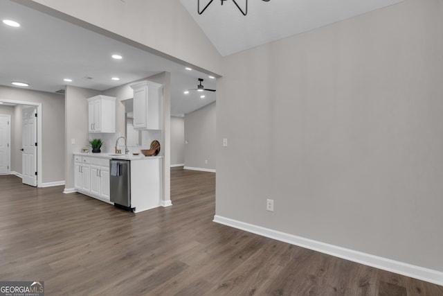 kitchen with stainless steel dishwasher, a sink, light countertops, and baseboards