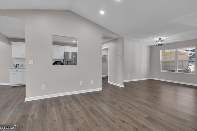 unfurnished living room featuring dark wood-type flooring, baseboards, and recessed lighting