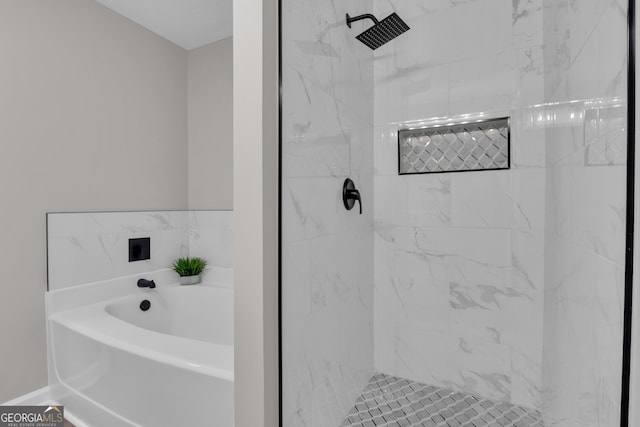 full bathroom featuring a garden tub and a marble finish shower