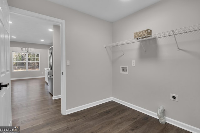 clothes washing area with dark wood finished floors, hookup for an electric dryer, hookup for a washing machine, and laundry area