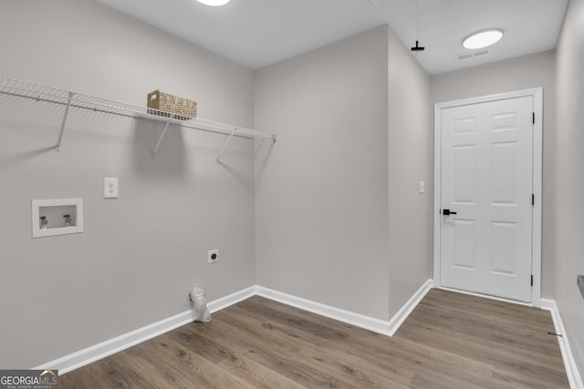 washroom with laundry area, wood finished floors, visible vents, baseboards, and electric dryer hookup