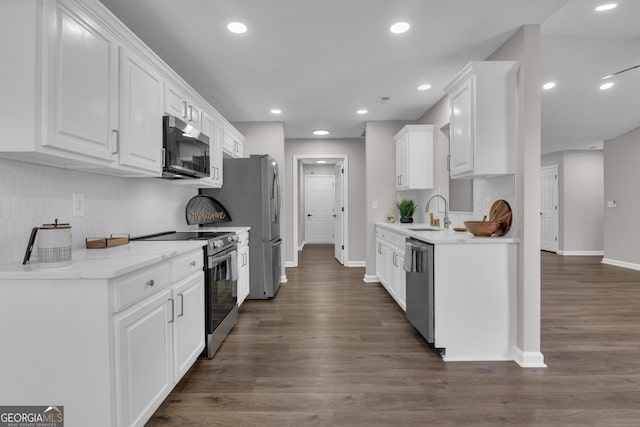 kitchen featuring white cabinets, appliances with stainless steel finishes, baseboards, and a sink