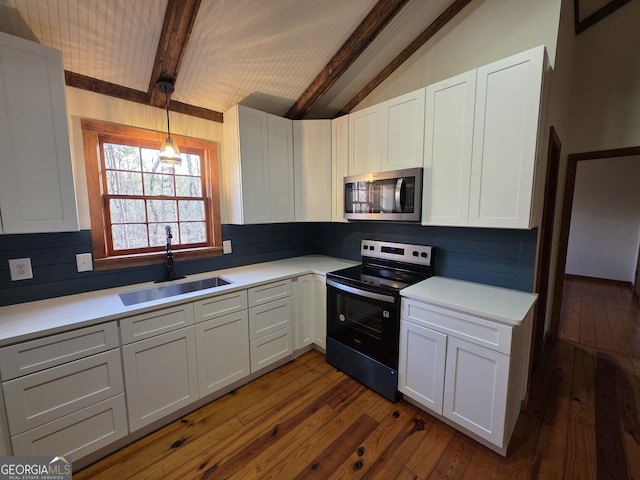 kitchen featuring a sink, lofted ceiling with beams, range with electric cooktop, stainless steel microwave, and dark wood-type flooring