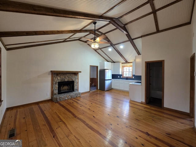 unfurnished living room featuring recessed lighting, visible vents, a ceiling fan, vaulted ceiling with beams, and light wood-style flooring