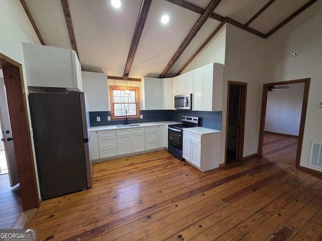 kitchen with decorative backsplash, stainless steel appliances, light wood-type flooring, and a sink