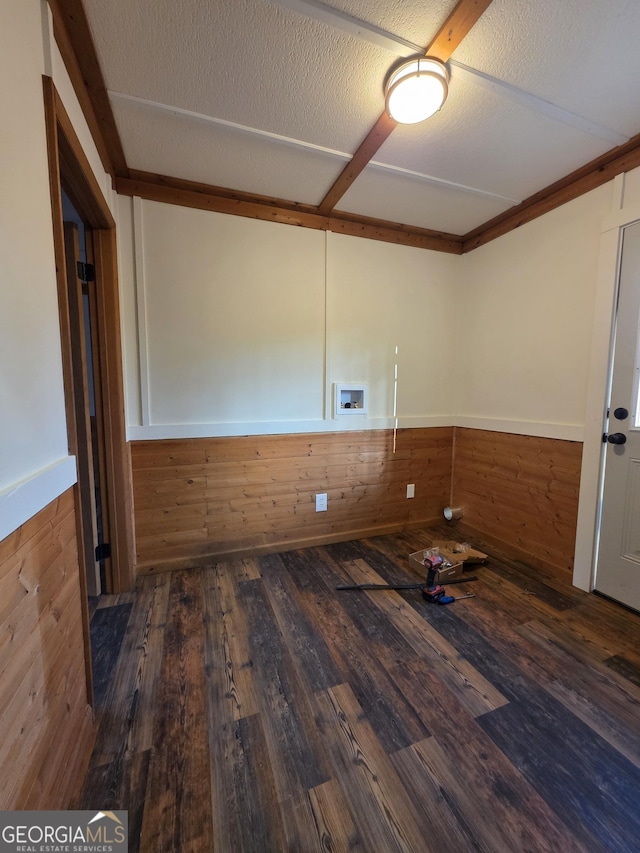 spare room with wood walls, wainscoting, and wood finished floors